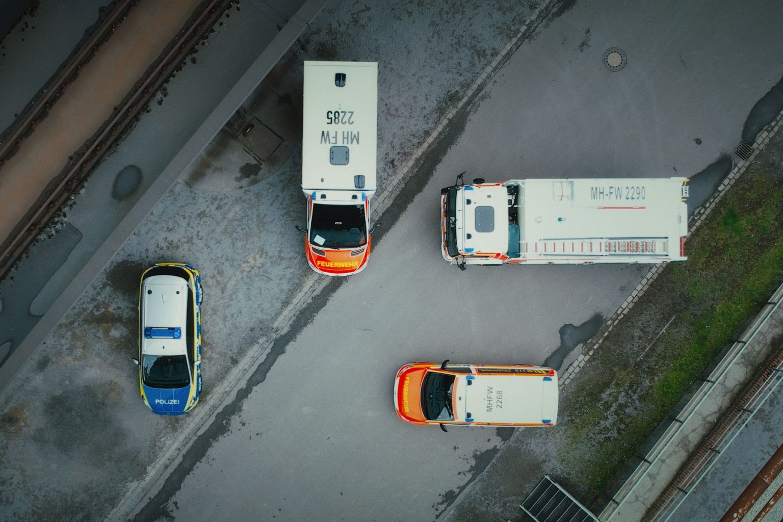Page Image Aerial Emergency Vehicles all Parked on concrete in different directions at 90 degrees to one another