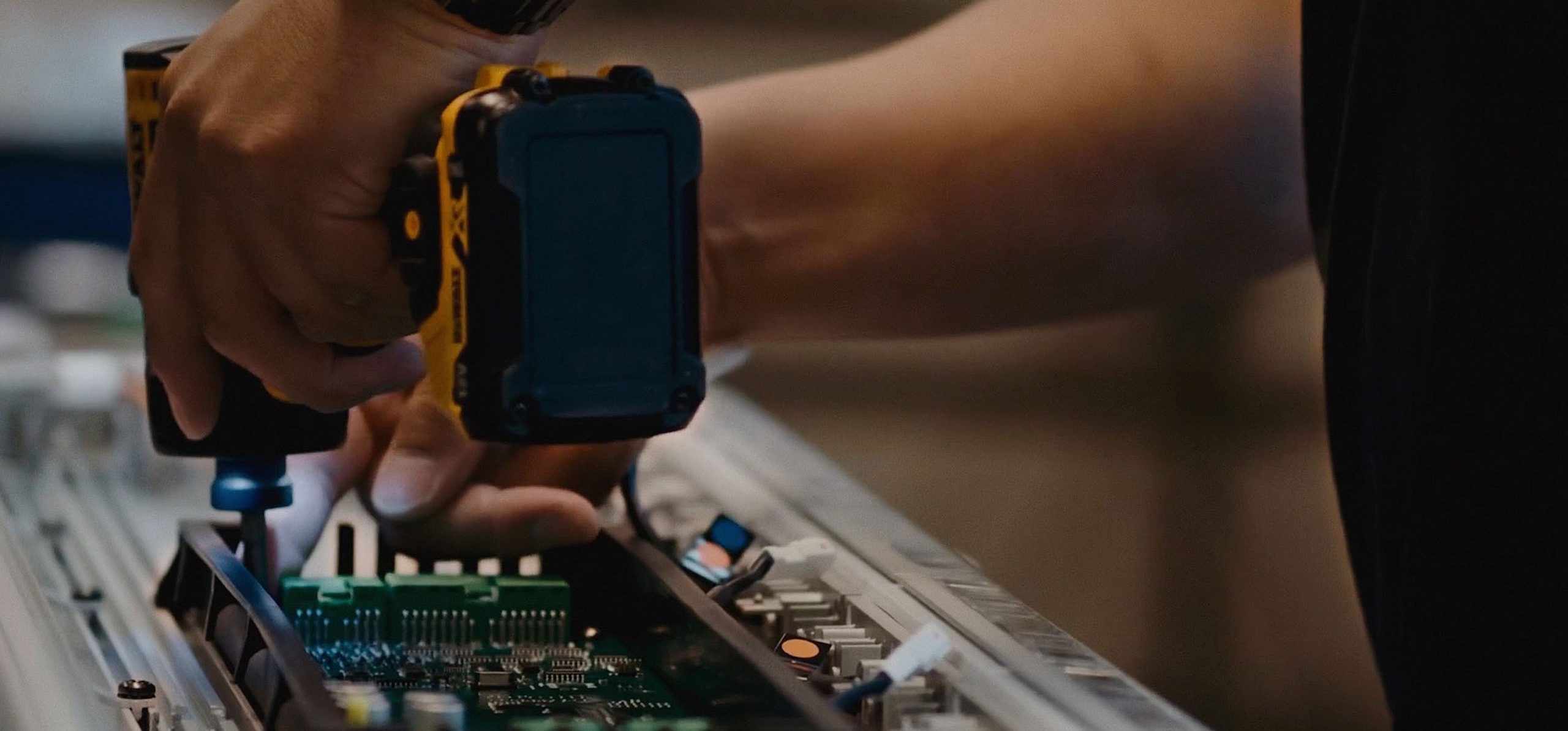Hero Image Lightbar Assembly Cropped Image of Worker Using Screwdriver on Lightbar with components exposed