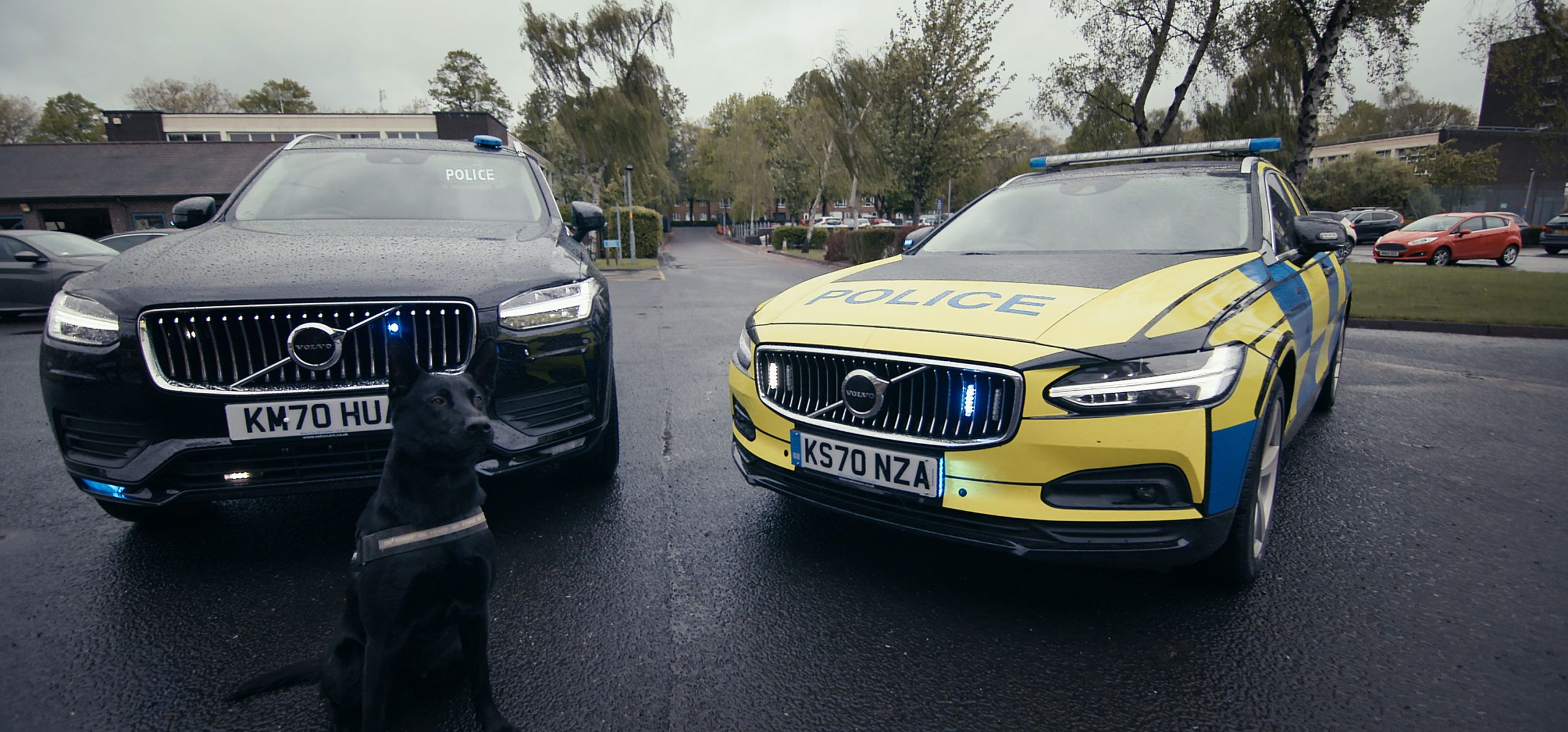 En svart bil och en polisbil framifrån. Referenser