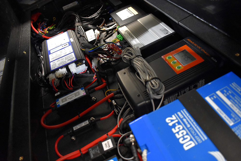 Angled close up shot of electronic equipment wired up inside of vehicle