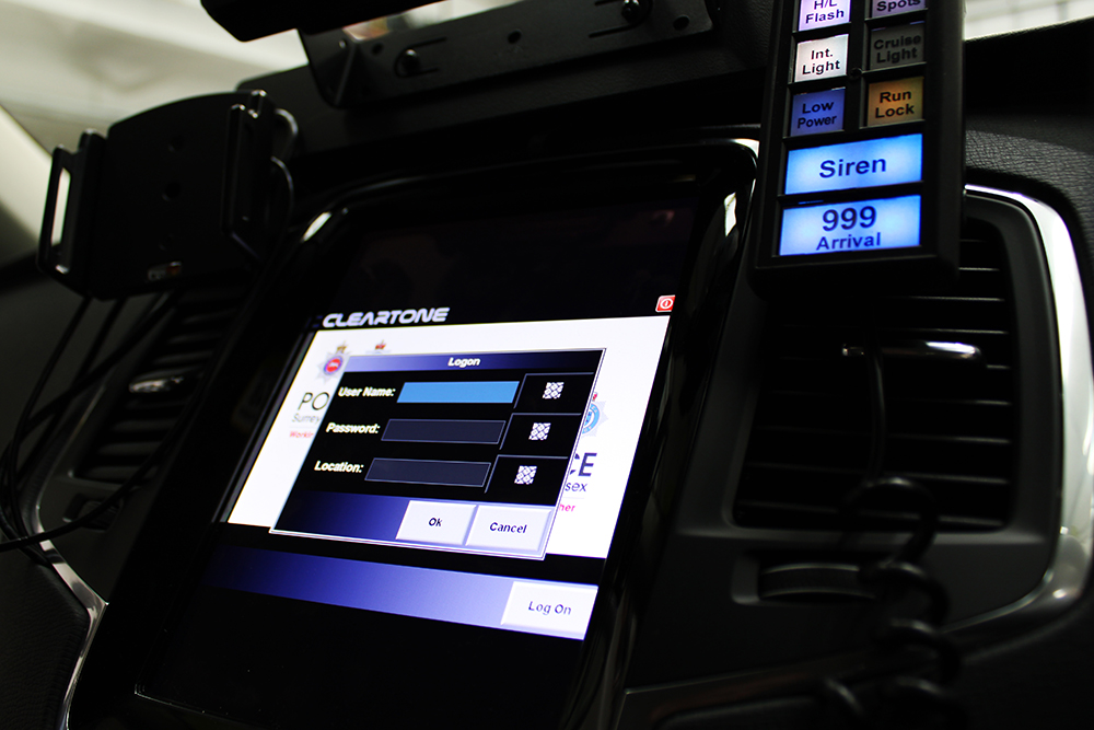 Close up of Infotainment Screen showing Cleartone logo and login form, lit up and surrounded by a dark vehicle dash supporting a Standby UK handset